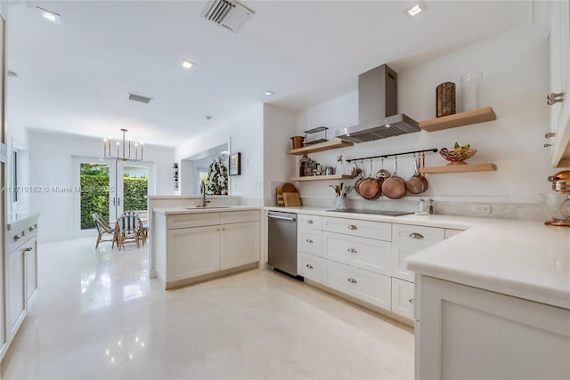 kitchen featuring wall chimney range hood, sink, hanging light fixtures, white cabinets, and stainless steel dishwasher