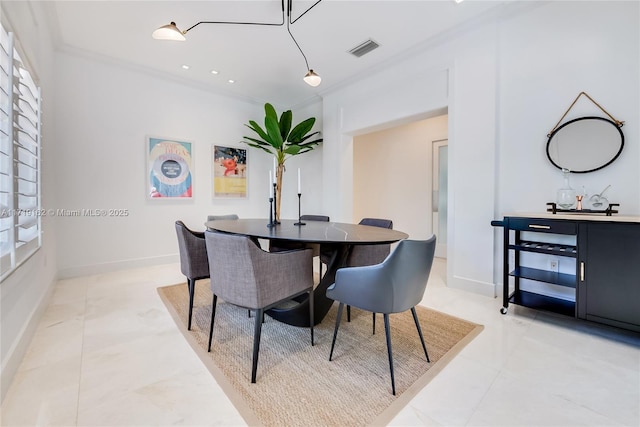 dining room with crown molding and light tile patterned flooring