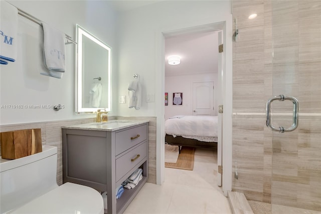 bathroom featuring tile patterned floors, vanity, toilet, and an enclosed shower