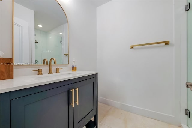 bathroom with vanity, a shower with shower door, and tile patterned floors