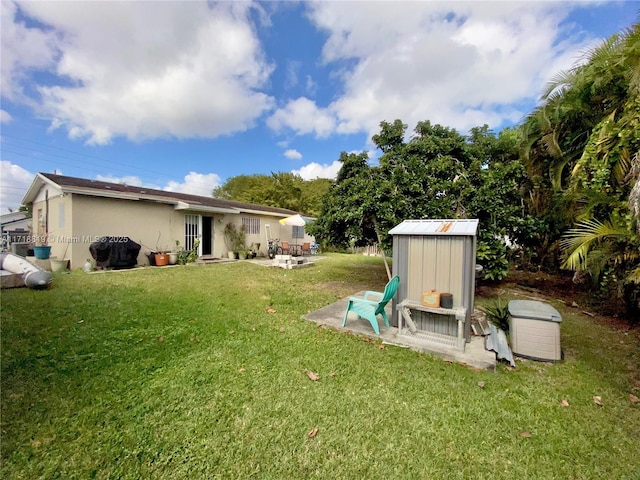 view of yard with a patio and a storage shed