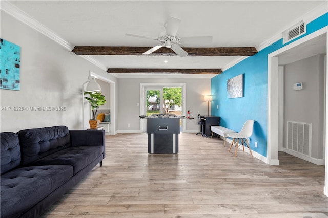 living room featuring ceiling fan, crown molding, beamed ceiling, and light wood-type flooring