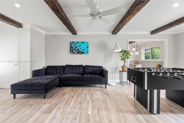 living room featuring hardwood / wood-style floors, ceiling fan, crown molding, and beam ceiling