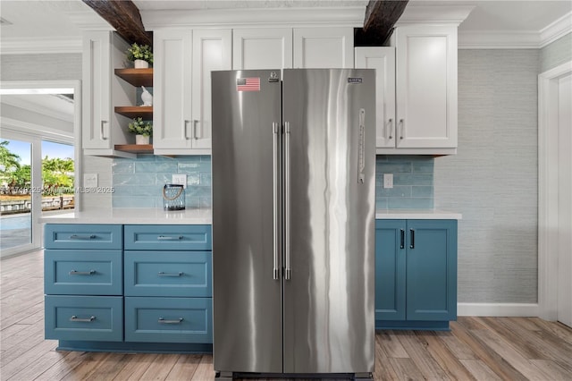 kitchen with blue cabinetry, white cabinetry, and high end fridge