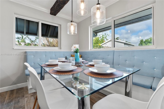 dining area featuring hardwood / wood-style floors, beamed ceiling, breakfast area, and ornamental molding