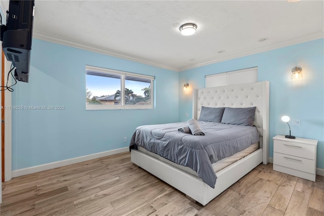 bedroom featuring light hardwood / wood-style floors and ornamental molding