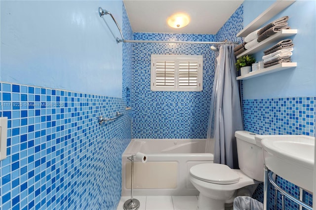 bathroom with tile patterned flooring, shower / bath combo, toilet, and tile walls