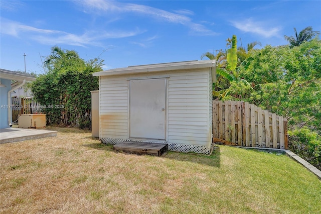 view of outdoor structure featuring a lawn