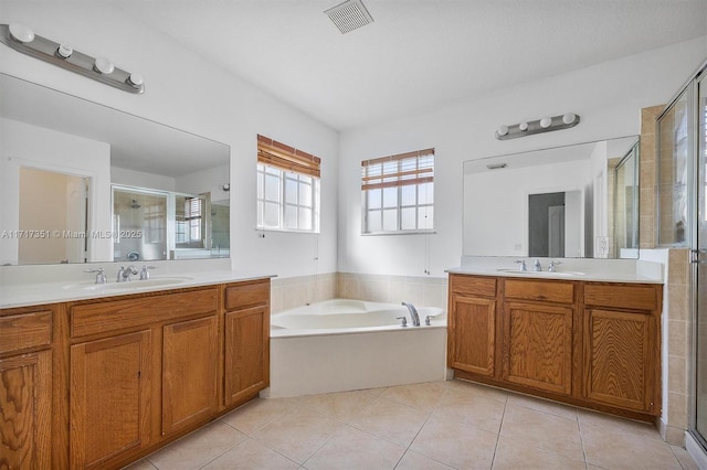 bathroom with tile patterned flooring, vanity, and independent shower and bath