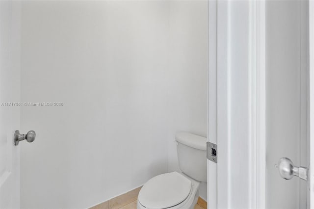 bathroom with tile patterned floors and toilet