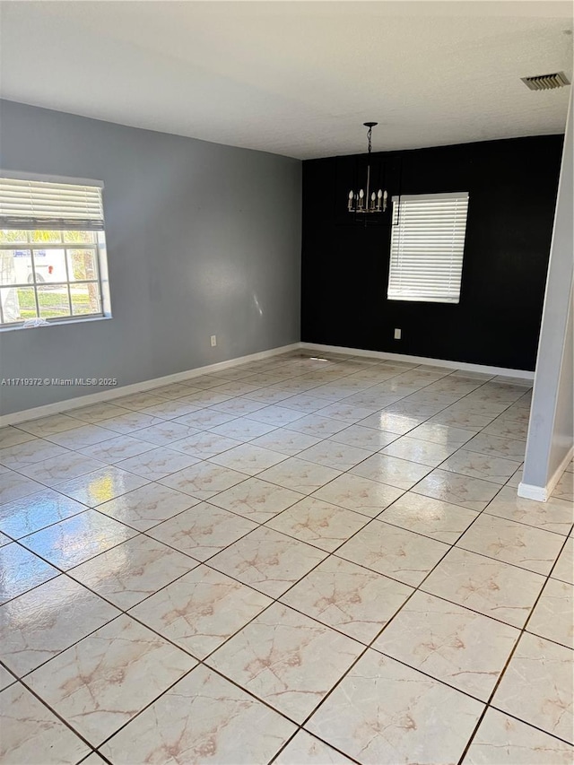 empty room with a notable chandelier