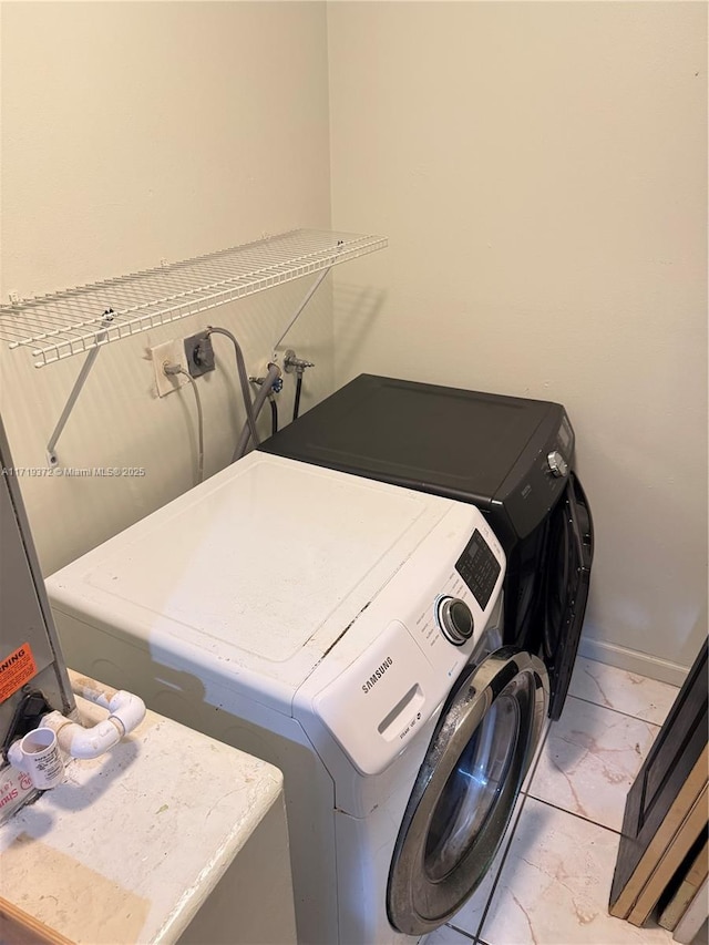 laundry room with washer and clothes dryer