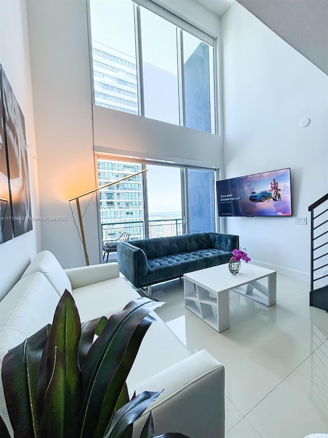 tiled living room with a wealth of natural light and a towering ceiling