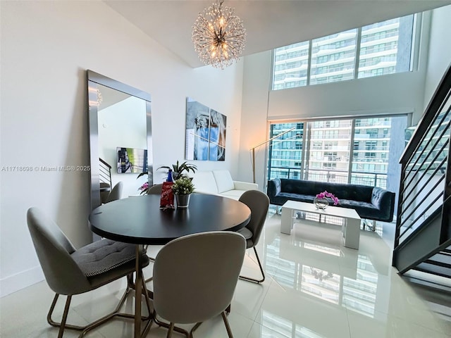 dining area with light tile patterned floors and an inviting chandelier