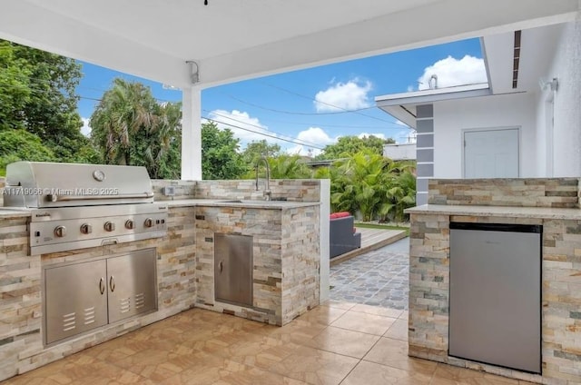 view of patio / terrace featuring area for grilling, grilling area, and sink