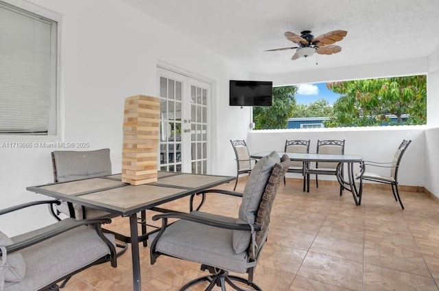 view of patio featuring french doors and ceiling fan