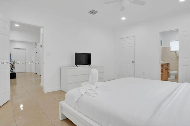 tiled bedroom with ensuite bath and ceiling fan