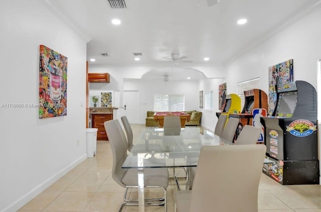 dining area featuring crown molding, light tile patterned flooring, and ceiling fan