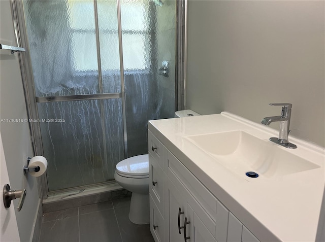 bathroom with vanity, toilet, tile patterned floors, and a shower with door