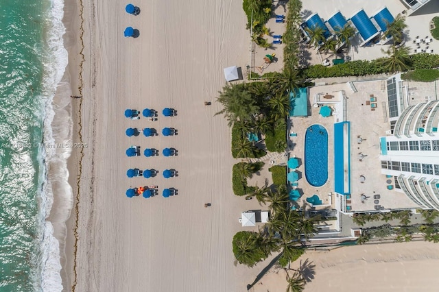 bird's eye view featuring a view of the beach and a water view