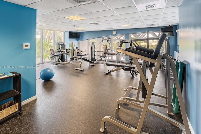 exercise room with a paneled ceiling