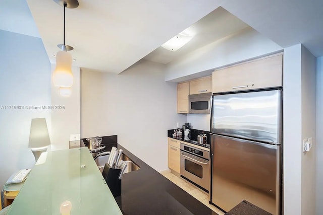 kitchen with light tile patterned flooring, pendant lighting, and appliances with stainless steel finishes