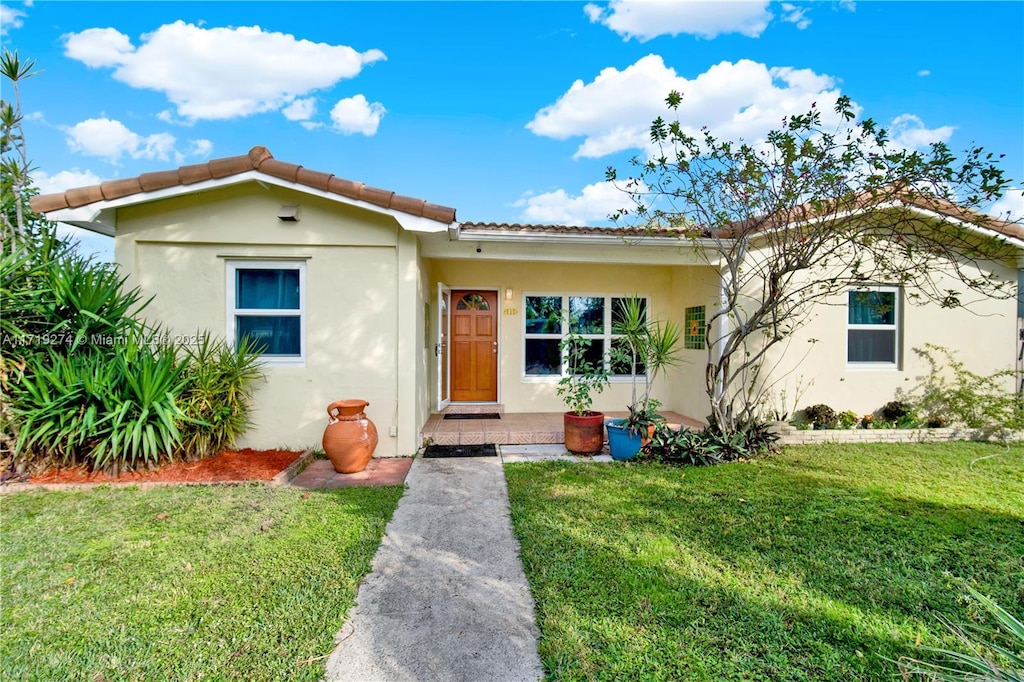 mediterranean / spanish-style home featuring a front yard