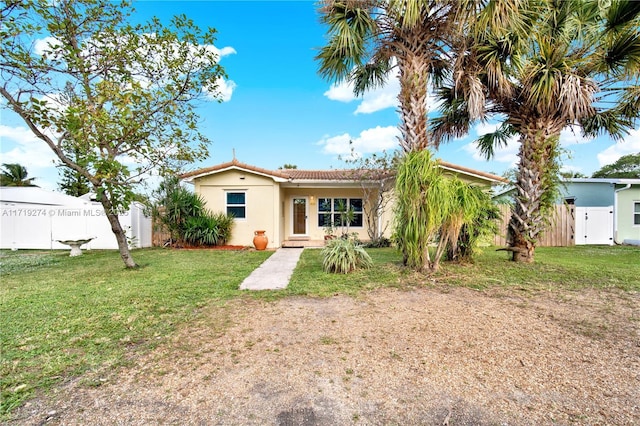 rear view of property featuring a yard