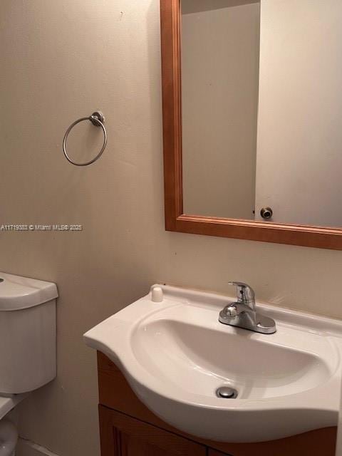 bathroom featuring vanity and toilet