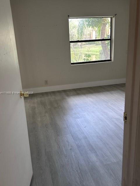 empty room with hardwood / wood-style floors