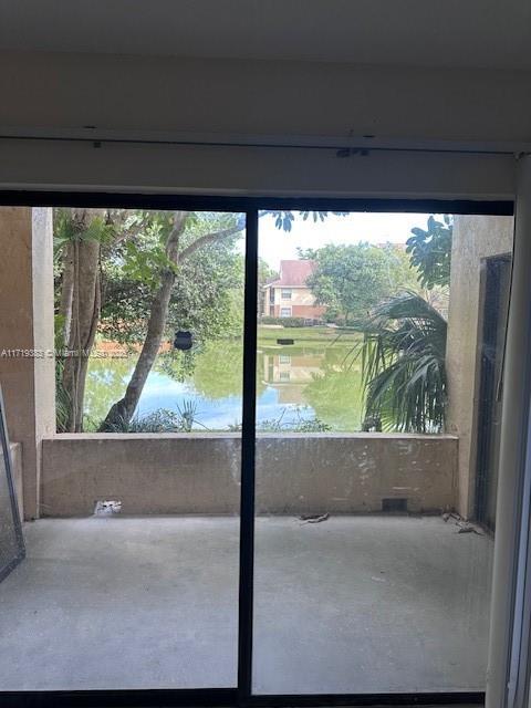 doorway to outside featuring a water view and a wealth of natural light