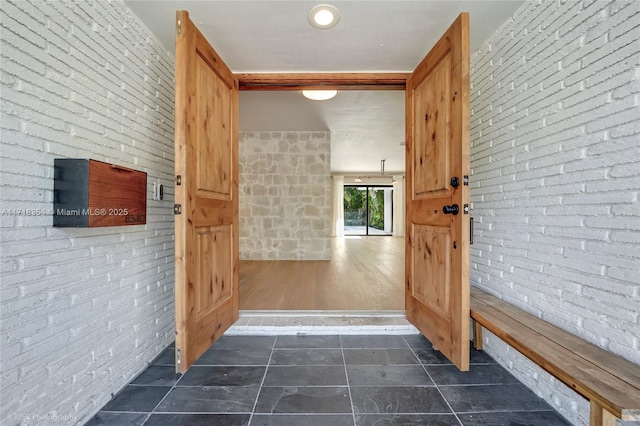 bathroom featuring brick wall