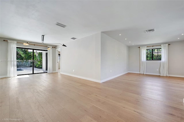 spare room featuring light hardwood / wood-style floors