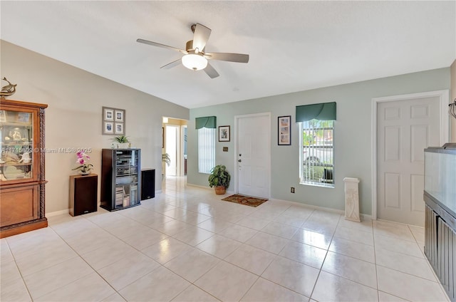 entrance foyer with wine cooler, ceiling fan, and light tile patterned floors