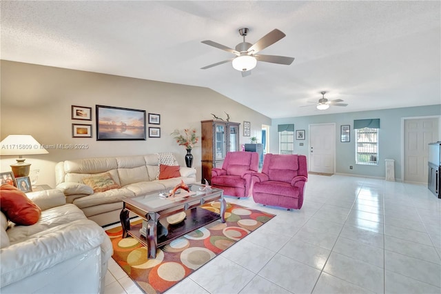 tiled living room featuring ceiling fan, a textured ceiling, and vaulted ceiling