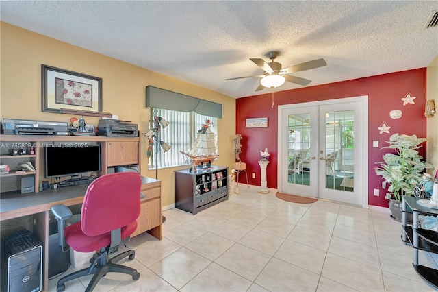 tiled office space with plenty of natural light, ceiling fan, a textured ceiling, and french doors