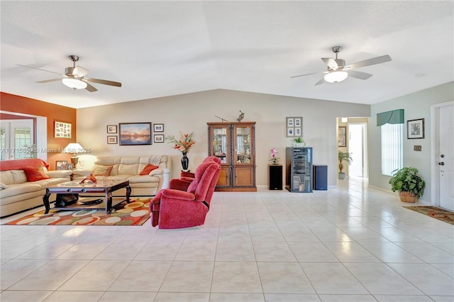 living room with ceiling fan, lofted ceiling, and light tile patterned flooring