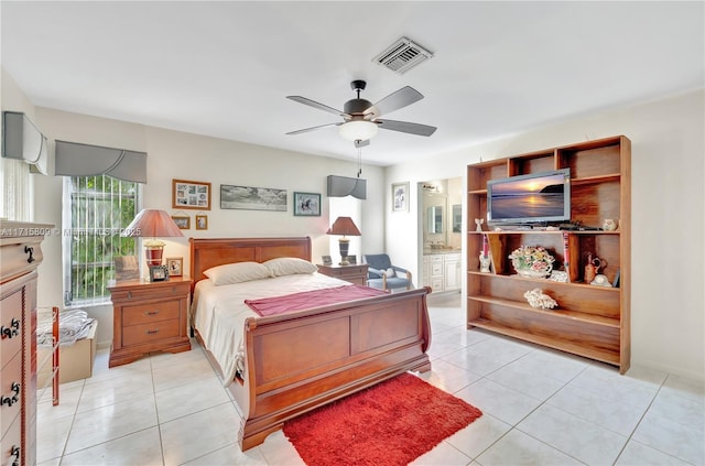 tiled bedroom with ensuite bath and ceiling fan