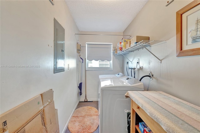 clothes washing area featuring carpet flooring, a textured ceiling, electric panel, and washer and clothes dryer