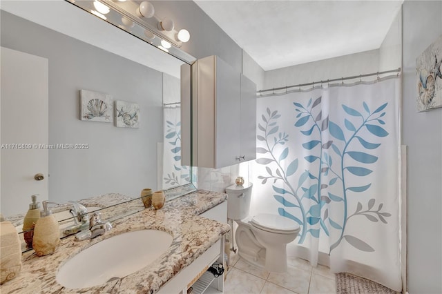 bathroom featuring sink, tile patterned flooring, and toilet