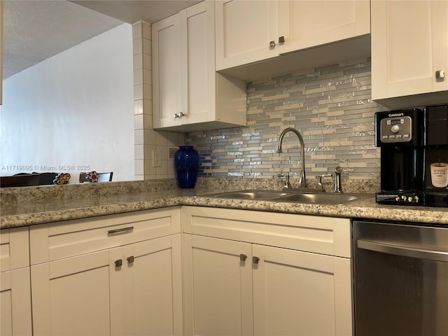 kitchen with backsplash, white cabinetry, sink, and dishwasher