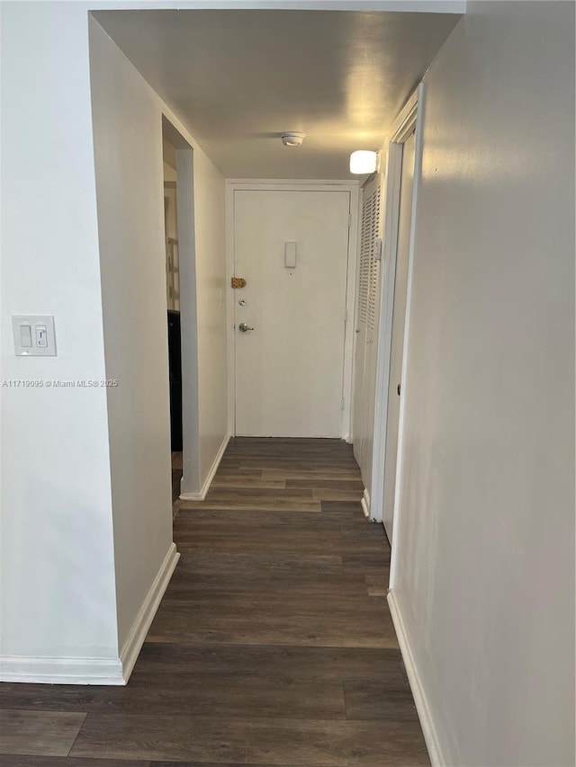 hallway featuring dark hardwood / wood-style flooring