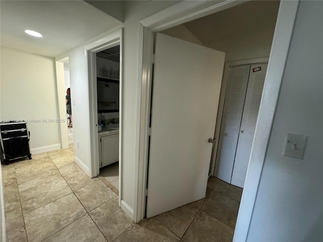 corridor featuring light tile patterned floors