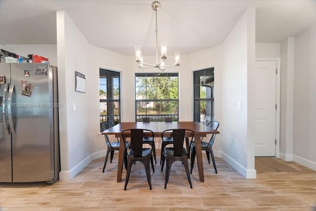 dining space with a chandelier and light hardwood / wood-style floors