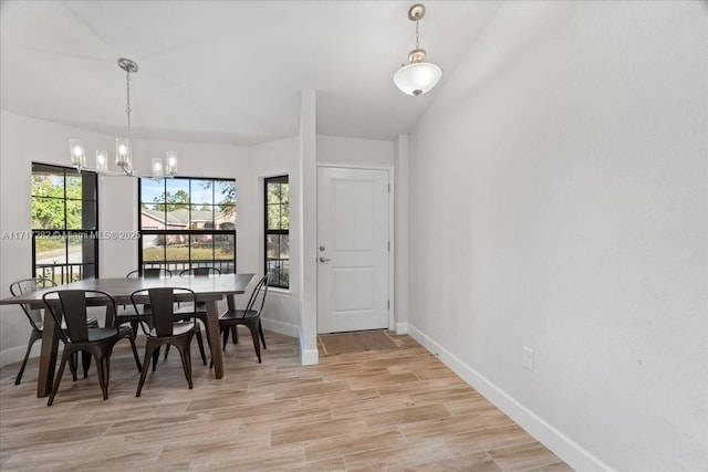 unfurnished dining area featuring lofted ceiling, light hardwood / wood-style flooring, and a notable chandelier