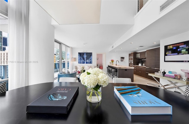 living room with floor to ceiling windows and sink