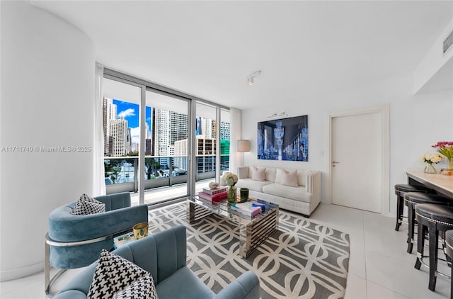 tiled living room featuring a wall of windows