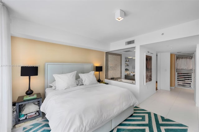 bedroom with light tile patterned floors