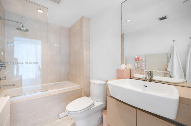 full bathroom with toilet, tile patterned flooring, vanity, and tiled shower / bath