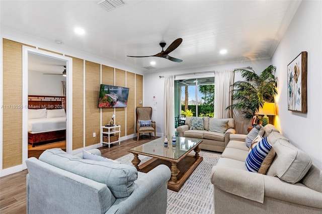 living room featuring ceiling fan and light wood-type flooring